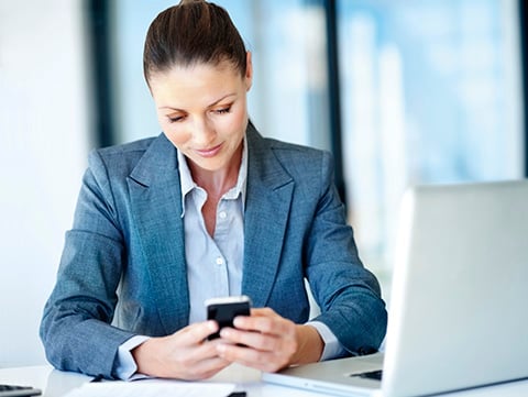 Woman looking using her phone to make online payments